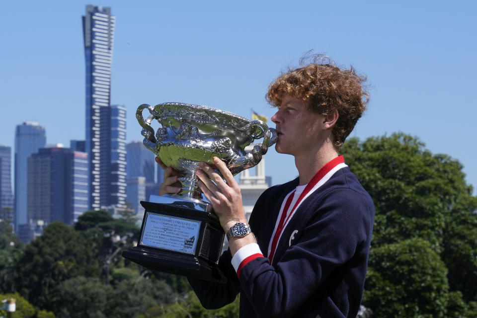 Jannik Sinner of Italy kisses the Norman Brookes Challenge Cup at a photo shoot the morning after defeating Daniil Medvedev of Russia in the men's singles final at the Australian Open tennis championships in Melbourne, Australia, Monday, Jan. 29, 2024. (AP Photo/Andy Wong)