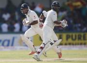 India's Cheteshwar Pujara (L) and Amit Mishra run between wickets during the second day of their third and final test cricket match against Sri Lanka in Colombo , August 29, 2015. REUTERS/Dinuka Liyanawatte