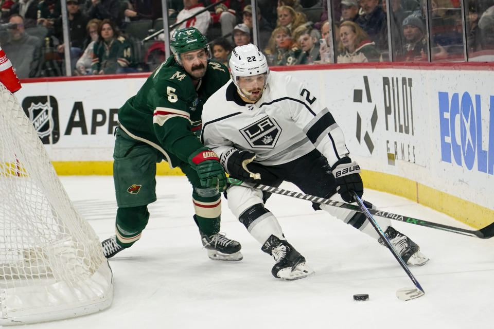 Minnesota Wild defenseman Jacob Middleton (5) tries to knock the puck away from Los Angeles Kings left wing Kevin Fiala (22) during the second period of an NHL hockey game Tuesday, Feb. 21, 2023, in St. Paul, Minn. (AP Photo/Craig Lassig)