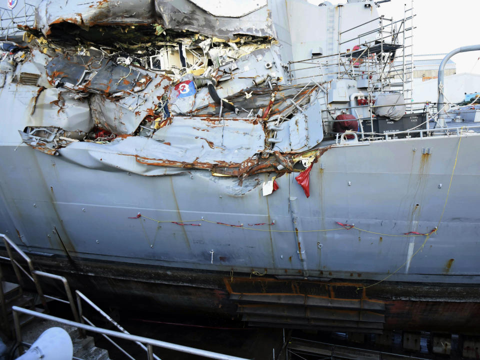 FILE - This July 11, 2017, file photo provided by the U.S. Navy shows the USS Fitzgerald in dry dock in Yokosuka, Japan, for repairs and assessment of damage sustained from a June 17 collision with a cargo ship in the waters off of Japan. Survivors and descendants of those killed when a container ship collided with the U.S. Navy destroyer off Japan's coast are suing the ship's Japanese charterer, according to a lawsuit filed Monday, Nov. 18, 2019, that details the survivors' scramble for safety as water rushed in. (Spc. 1st Class Leonard Adams/U.S. Navy via AP)