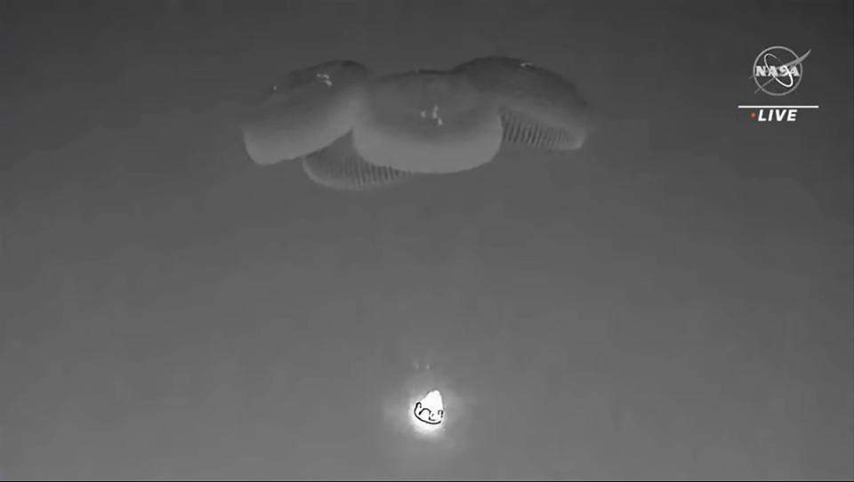 In this image from video made available by NASA, a SpaceX capsule, slowed by parachutes, approaches the surface of the Atlantic Ocean off the Florida coast, Monday, Sept. 4, 2023, as it returns to Earth with NASA astronaut Stephen Bowen, United Arab Emirates astronaut Sultan al-Neyadi, NASA astronaut Warren (Woody) Hoburg and Roscosmos cosmonaut Andrey Fedyaev after a six-month stay at the International Space Station. (NASA via AP)