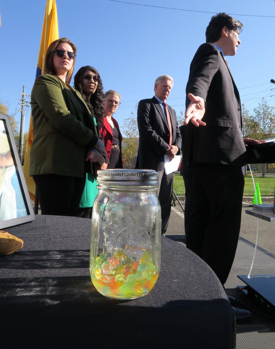 Consumer Product Safety Commission (CPSC) Chairman Alex Hoehn-Saric gestures towards a jar filled with water beads during a Monday, November 13, 2023, press conference outside Jersey Shore University Medical Center in Neptune, NJ. Congressman Frank Pallone (D-NJ, second from right) is planning to introduce legislation to ban that product that are marketed for kids. Also shown are mothers who had children killed or injured by the water beads (l-r): Folichia Mitchell, Ashley Haugen and Taylor Bethard.