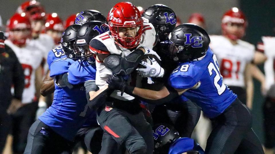 Scott County’s Ellis Huguely (11) was wrapped up by a swarm of Lexington Catholic defenders during their matchup earlier this season. Scott County hosts Cooper on Friday night.