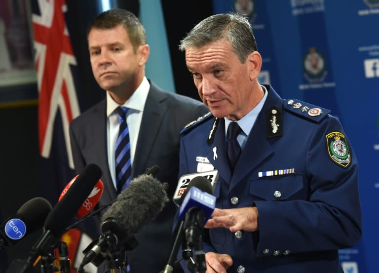 New South Wales police commissioner Andrew Scipione (R) and state Premier Mike Baird speak to the media in Sydney on October 3, 2015, a day after a 15-year-old gunman shot dead a civilian police employee