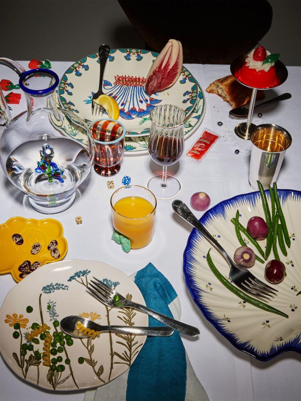 a table is filled with plates of varying sizes and colors