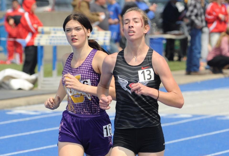 Unioto's Cameron Walker (left) paces Circleville's Maddux Bigam during the girls 1600-meter run in the Division II district track and field meet at Washington High School on May 20, 2023.