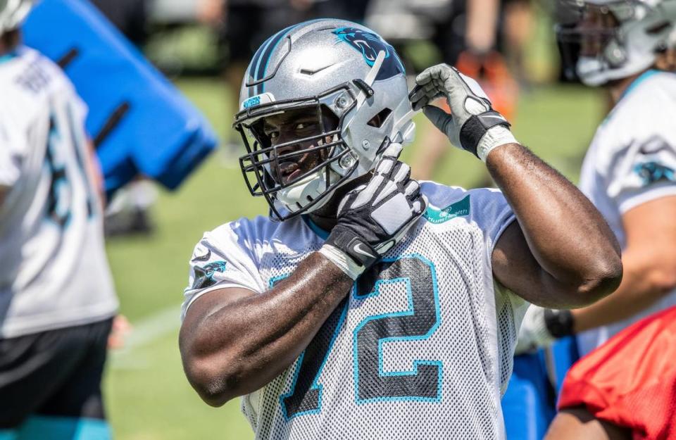 Carolina Panthers right tackle Taylor Moton adjusts his helmet during practice in Charlotte, N.C., on Wednesday, June 16, 2021.