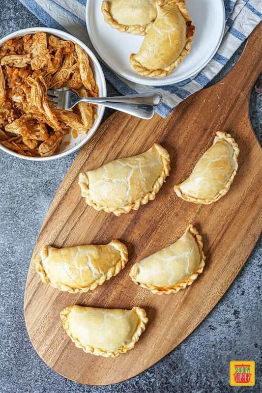 <p>Sunday Supper Movement</p><p>Deliciously buttery, flaky and flavorful little pillows of chicken with caramelized onions. </p><p><strong>Get the recipe:</strong> <a href="https://sundaysuppermovement.com/chicken-empanada-recipe/" rel="nofollow noopener" target="_blank" data-ylk="slk:Chicken Empanada Recipe;elm:context_link;itc:0;sec:content-canvas" class="link rapid-noclick-resp">Chicken Empanada Recipe</a></p><p><strong>Related:</strong> <a href="https://parade.com/233050/vianneyrodriguez/12-decadent-latin-thanksgiving-desserts/" rel="nofollow noopener" target="_blank" data-ylk="slk:12 Decadent Latin Thanksgiving Desserts;elm:context_link;itc:0;sec:content-canvas" class="link rapid-noclick-resp"><strong>12 Decadent Latin Thanksgiving Desserts</strong></a></p>