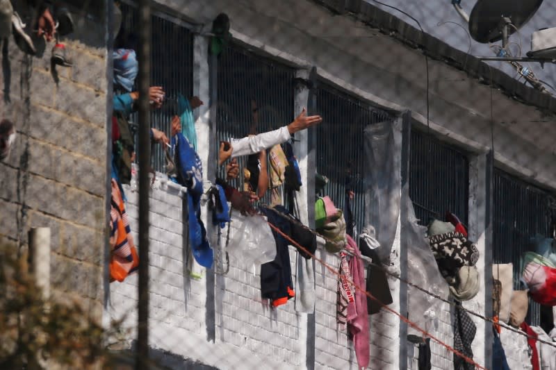 Prisoners are seen in cell windows inside the La Modelo prison after a riot by prisoners demanding government health measures against the spread of the coronavirus disease (COVID-19) in Bogota