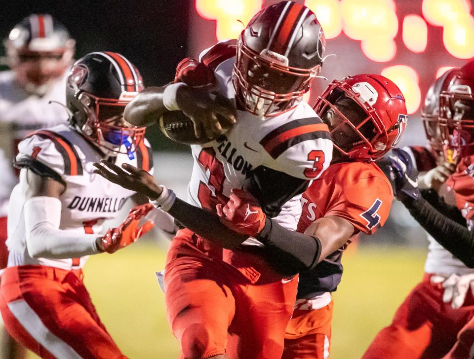 Dunnellon quarterback Dylan Curry (3) makes yards against Vanguard Zamaryion Farmer-mccray (4) as Vanguard takes on Dunnellon at Booster Stadium in Ocala, FL on Friday, September 8, 2023. [Alan Youngblood/Ocala Star-Banner]