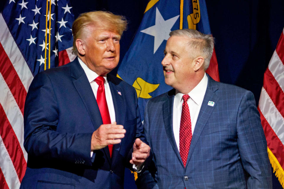 Donald Trump takes the stage with NCGOP Chairman Michael Whatley after being announced. (Melissa Sue Gerrits / Getty Images file)