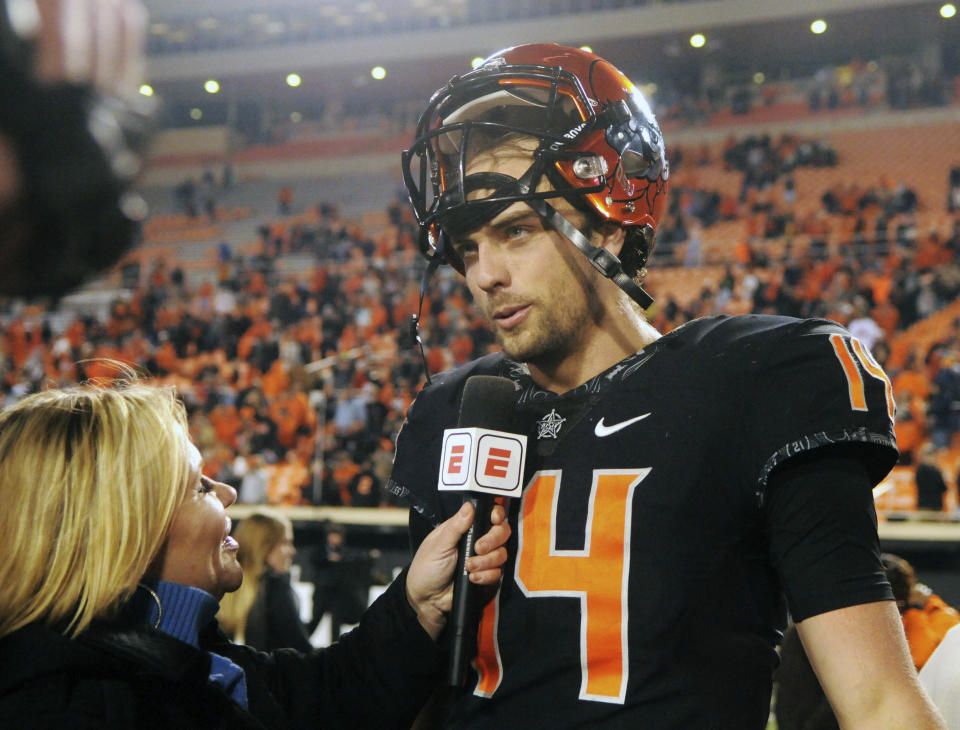 Oklahoma State quarterback Taylor Cornelius speaks with a reporter following an NCAA college football game in Stillwater, Okla., Saturday, Nov. 17, 2018. Oklahoma State defeated West Virginia 45-41. (AP Photo/Brody Schmidt)