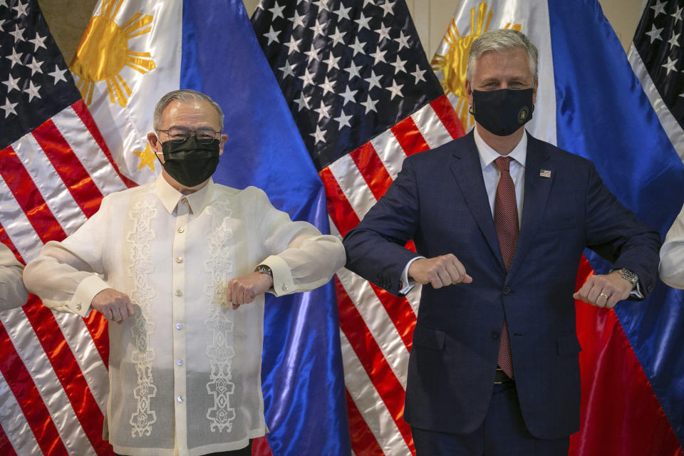 U.S. National Security Advisor Robert O'Brien, right, and Philippine Foreign Secretary Teodoro Locsin Jr. elbow bump after the turnover ceremony of defense articles at the Department of Foreign Affairs in Pasay City, Metro Manila, Philippines, Monday, Nov. 23, 2020. (Eloisa Lopez/Pool Photo via AP)