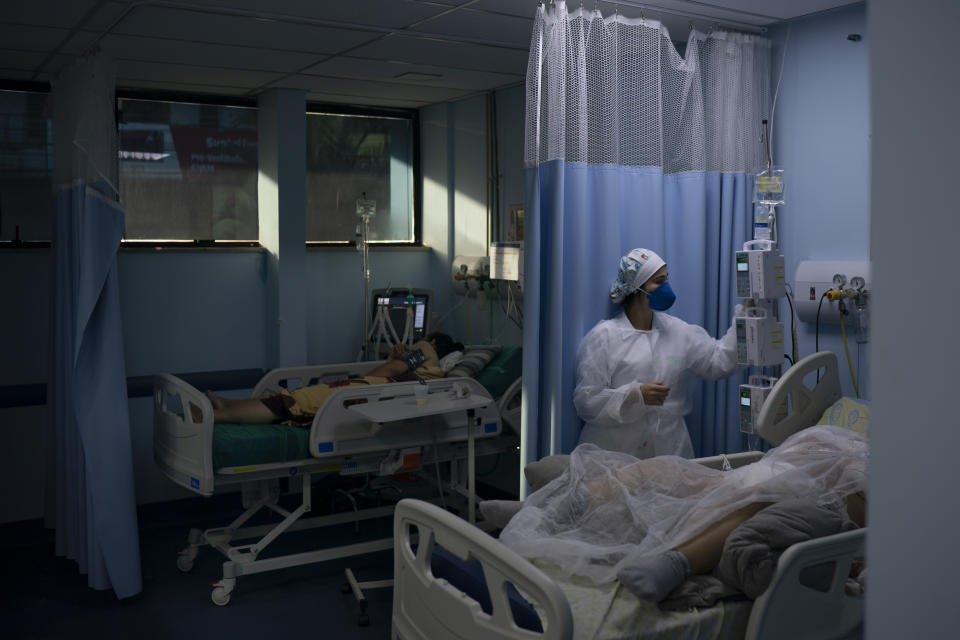 COVID-19 patients are treated in the municipal hospital of Sao Joao de Meriti, Rio de Janeiro state, Brazil, Thursday, April 8, 2021. (AP Photo/Felipe Dana)