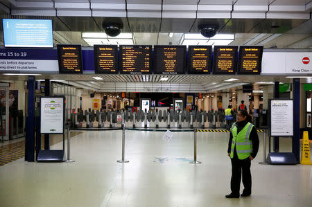 Boards advising passengers of industrial action by Southern railway workers are displayed at Victoria station in London, Britain December 13, 2016. REUTERS/Neil Hall/File Photo