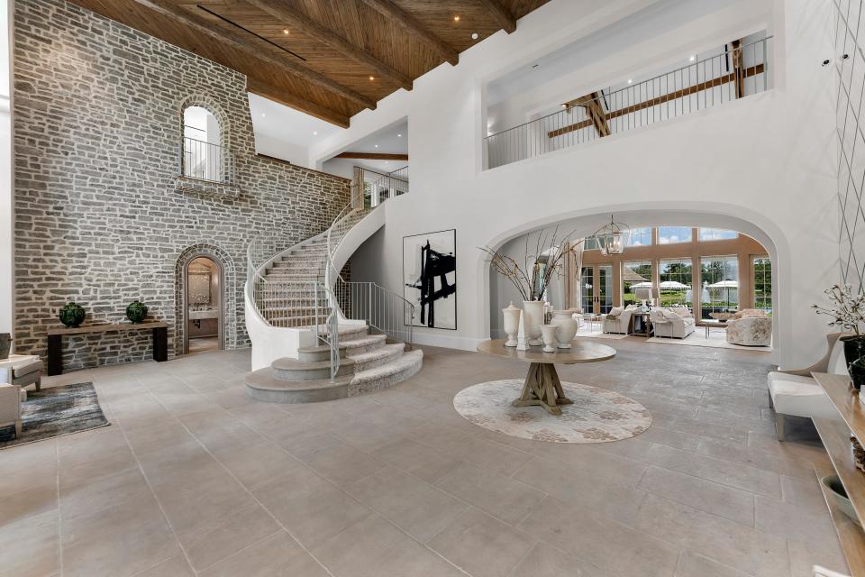 The entry foyer has French limestone floors, a French oak ceiling and a custom-designed stone staircase.