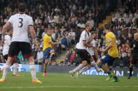 Arsenal's Lukas Podolski scores his second goal during the Barclays Premier League match at Craven Cottage, London.