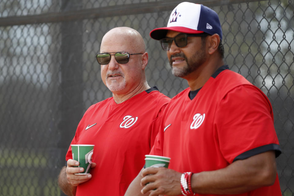FILE - In this Feb. 17, 2020, file photo, Washington Nationals general manager Mike Rizzo, left, talks with manager Dave Martinez during spring training baseball practice in West Palm Beach, Fla. (AP Photo/Jeff Roberson, File)