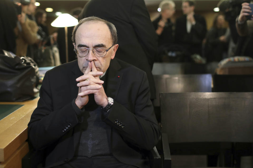 FILE - In this Jan. 7, 2019 file photo, French Cardinal Philippe Barbarin waits for the start of his trial at the Lyon courthouse, central France. Pope. A French court on Thursday March 7, 2019 is expected to acquit a cardinal and five other defendants accused of protecting a pedophile priest, but alleged victims say France's most important church sex abuse trial has at least allowed them to bring the affair into the open. (AP Photo/Laurent Cipriani, File)