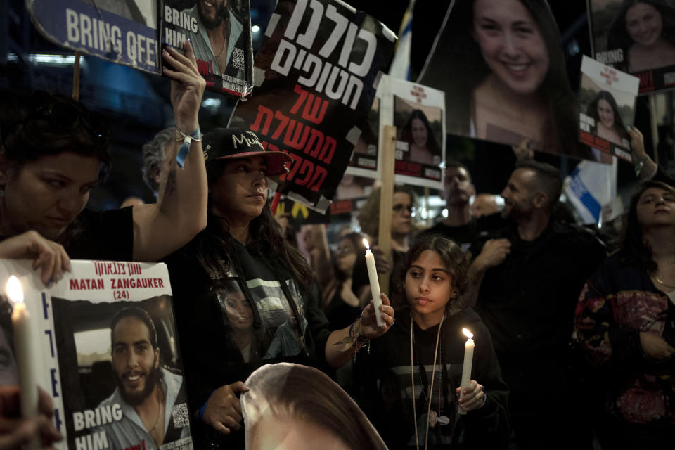 Released hostage Ilana Gritzewsky, center, whose boyfriend, Matan Zangauker, held hostage by Hamas in the Gaza Strip, stands with Matan's family at a march to call on Israeli Prime Minister Benjamin Netanyahu's government to make a deal to free their loved ones, in Tel Aviv, Israel, Wednesday, May 8, 2024. (AP Photo/Maya Alleruzzo)