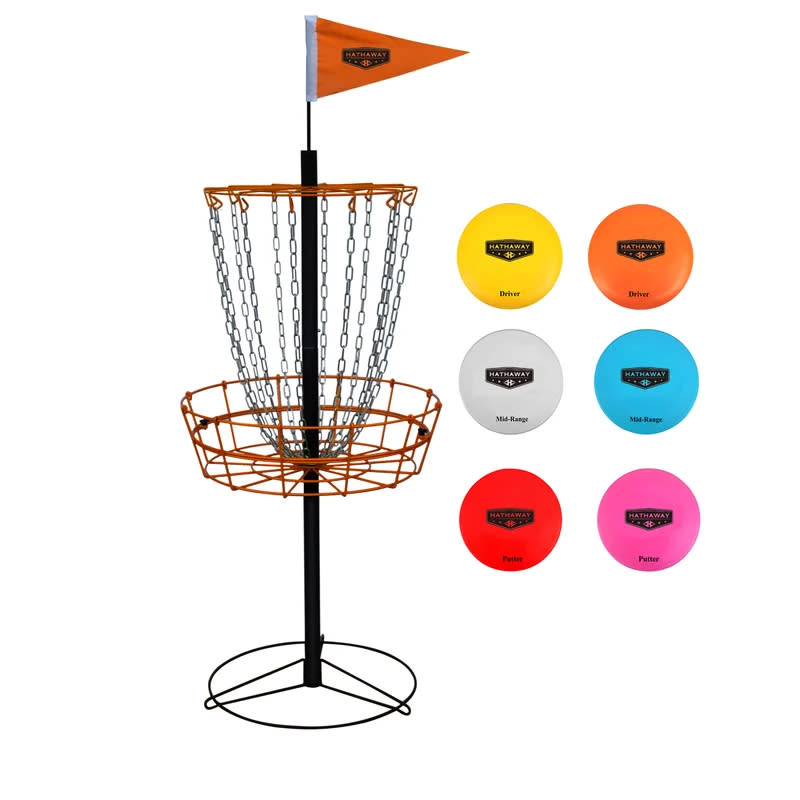 Disc golf basket with a flag on top and an assortment of discs to the right side