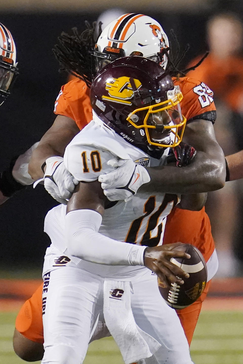 Central Michigan quarterback Daniel Richardson (10) is sacked by Oklahoma State defensive end Tyler Lacy (89) during the second half of an NCAA college football game Thursday, Sept. 1, 2022, in Stillwater, Okla. (AP Photo/Sue Ogrocki)