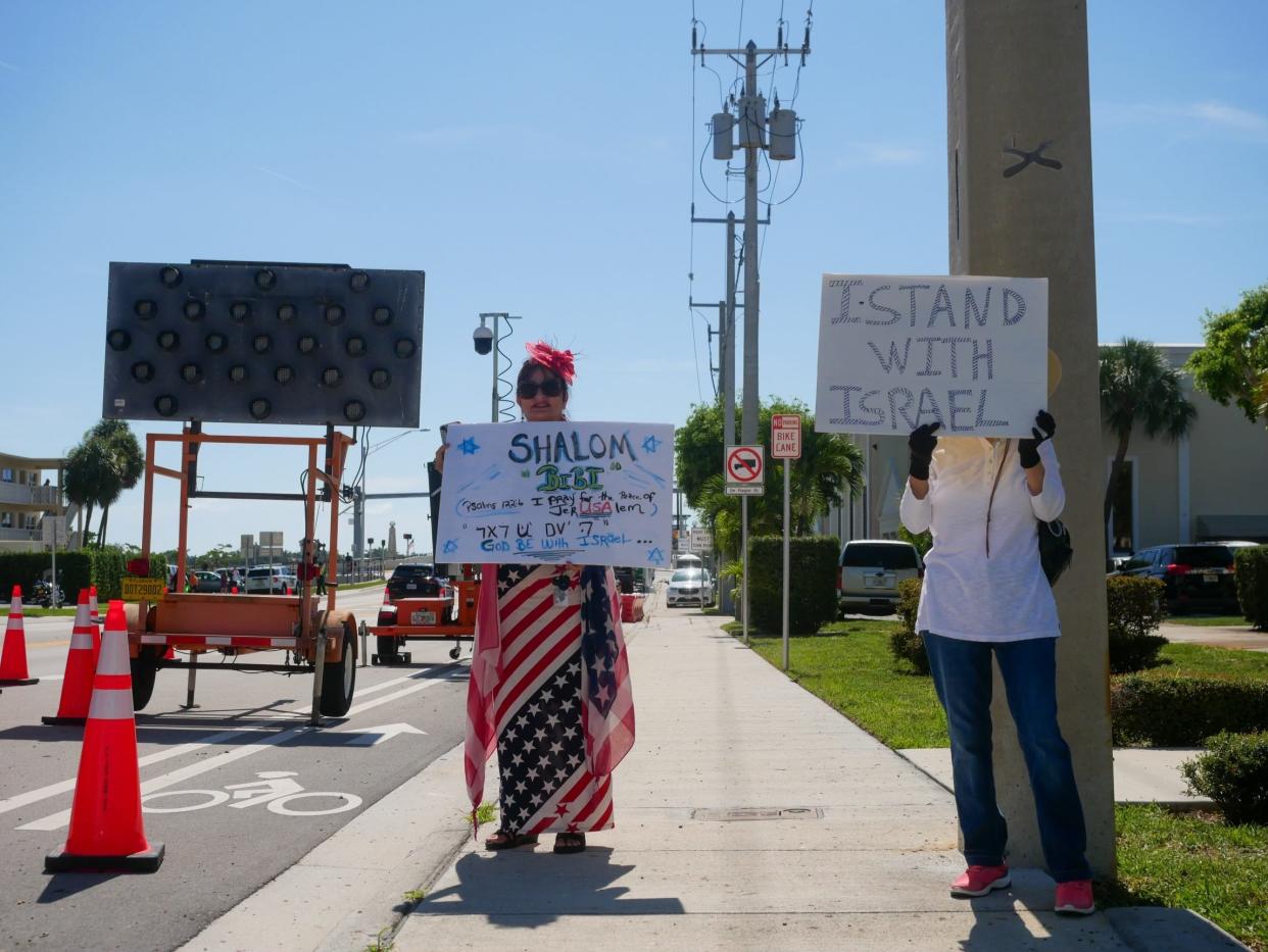 Supporters of former President Donald Trump and Israeli Prime Minister Benjamin Netanyahu carry signs along Southern Boulevard just west of the Southern Boulevard Bridge in West Palm Beach, ahead of the leaders' meeting at Mar-a-Lago in Palm Beach on Friday, July 26.