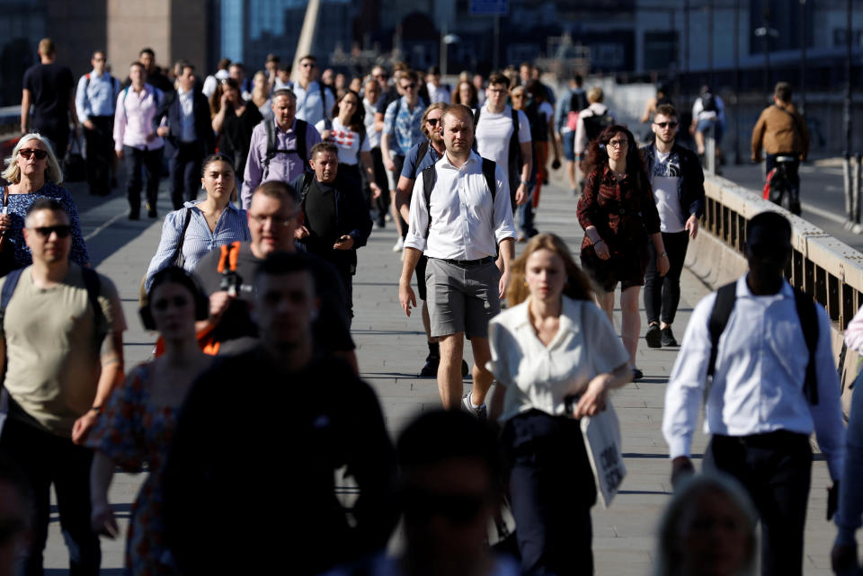 cost of living crisis People walk on London Bridge, the day after a national rail strike, during six days of travel disruption, in London, Britain, June 22, 2022. REUTERS/Peter Cziborra