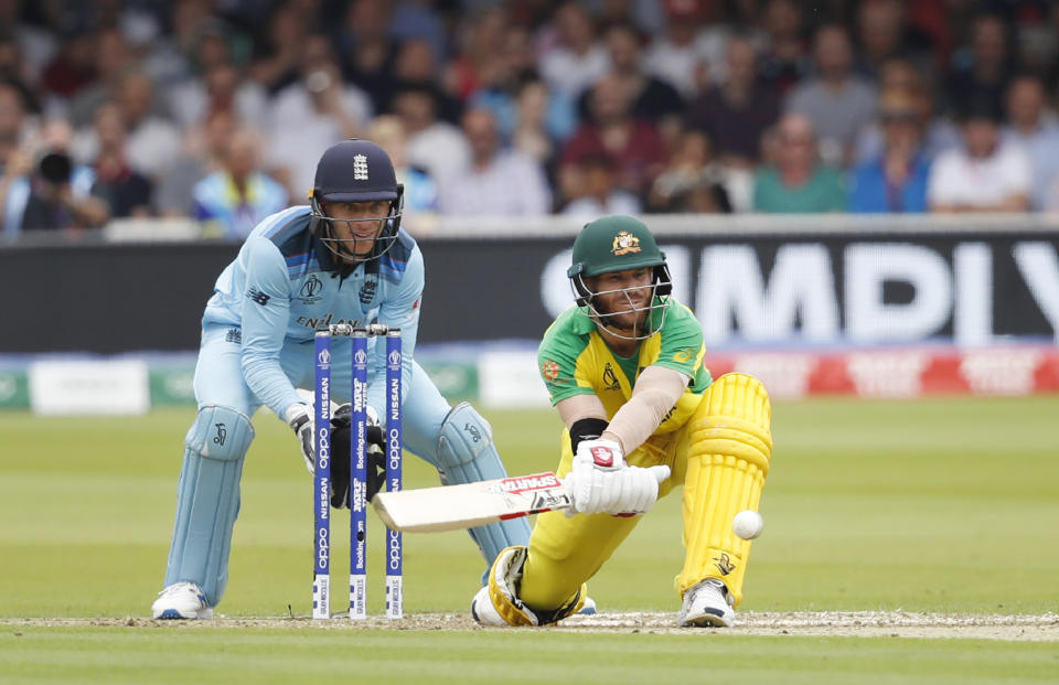 Australia's David Warner plays a shot off the bowling of England's Adil Rashid during their Cricket World Cup match between England and Australia at Lord's cricket ground in London, Tuesday, June 25, 2019. (AP Photo/Alastair Grant)