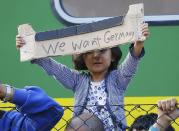 A young migrant girl holds up a sign during a protest in front of a train at Bicske railway station, Hungary, September 4, 2015. REUTERS/Leonhard Foeger