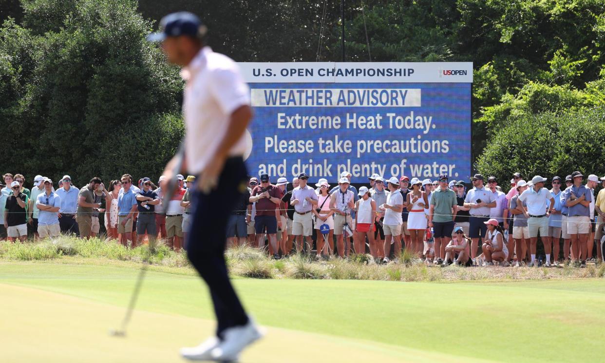 <span>A leaderboard announces extreme heat in the area during the third round of the 124th US Open in Pinehurst, North Carolina, on Saturday.</span><span>Photograph: Gregory Shamus/Getty Images</span>