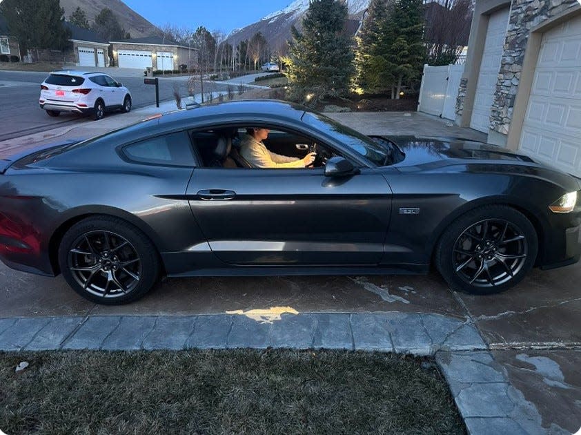 Joseph Tegerdine, 18, of Springville, Utah, sits in his 2020 Ford Mustang purchased in recent weeks by his father, Joe. Joseph, who has been in cancer treatment with multiple surgeries for the past five years, always dreamed of owning a pony.