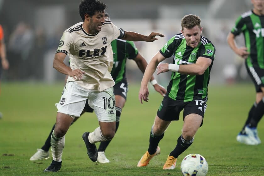 Los Angeles FC forward Carlos Vela (10) defends against Austin FC forward Jon Gallagher (17) during the second half of an MLS soccer match in Los Angeles, Wednesday, May 18, 2022. (AP Photo/Ashley Landis)