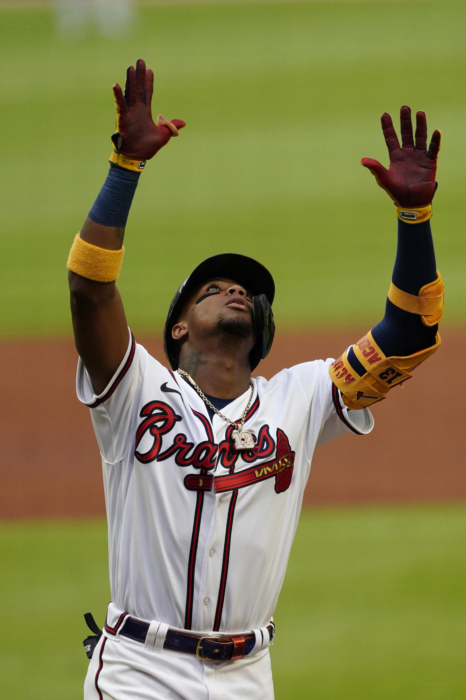 Atlanta Braves' Ronald Acuna Jr. gestures as he crosses home plate after hitting a home run during the first inning of the team's baseball game against the New York Mets on Wednesday, June 30, 2021, in Atlanta. (AP Photo/John Bazemore)