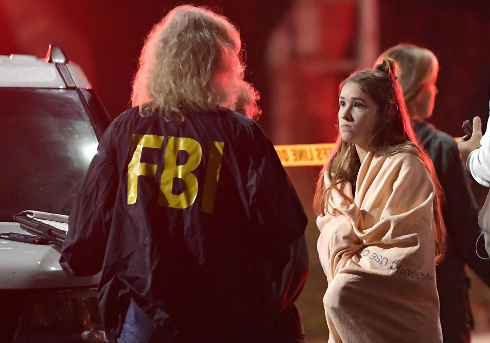 A potential witness talks to a member of the FBI after a mass shooting in California. Source: Yahoo News UK