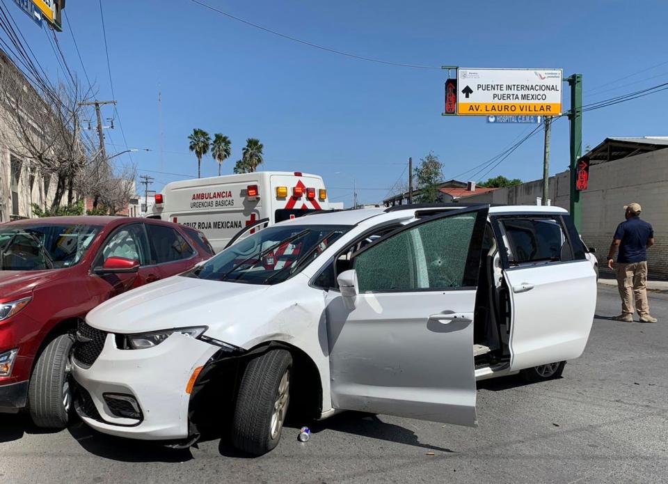 A member of the Mexican security forces stands next to a white minivan with North Carolina plates and several bullet holes, at the crime scene where gunmen kidnapped four U.S. citizens who crossed into Mexico from Texas, Friday, March 3, 2023. Mexican President Andres Manuel Lopez Obrador said the four Americans were going to buy medicine and were caught in the crossfire between two armed groups after they had entered Matamoros, across from Brownsville, Texas, on Friday.