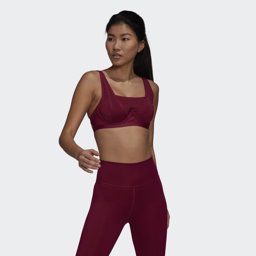 Girl wearing maroon sports bra.