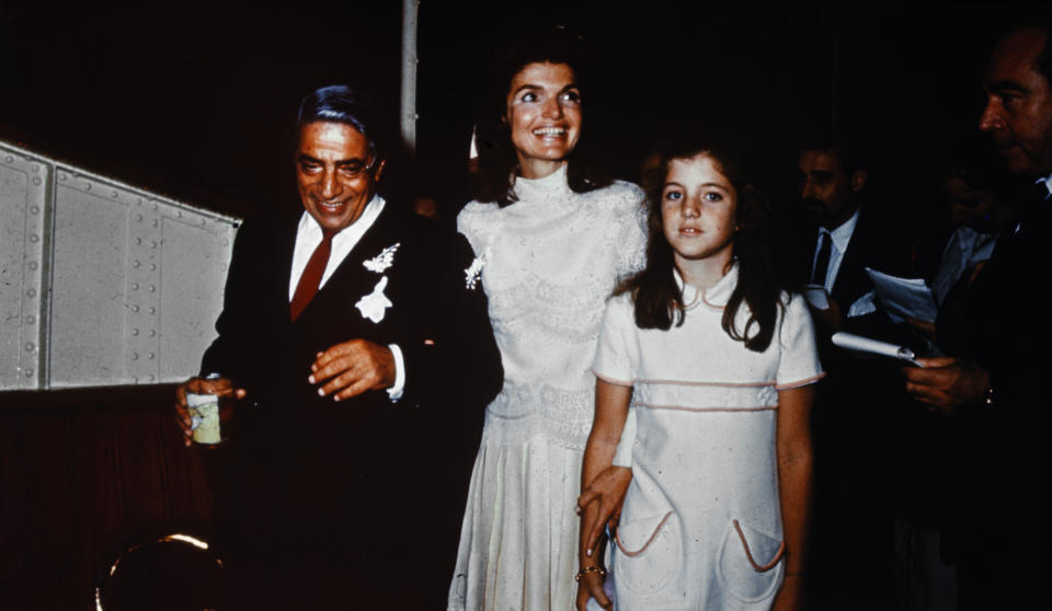 (Original Caption) Bearing traces of confetti, Mr. and Mrs. Aristotle Onassis, (Jackie Kennedy), are shown at their October 20th wedding on Onassis' private island. Caroline Kennedy, 10, stands next to her mother.