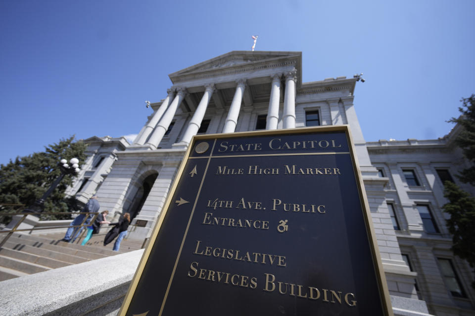 FILE - Visitors stand on the west steps of the Colorado state Capitol, Sunday, April 23, 2023, in Denver. Colorado is set to become the first state to sign a "right to repair" law allowing farmers to fix their own equipment with a bill signing Tuesday afternoon, April 25, by Democratic Gov. Jared Polis of Colorado. The law will force manufacturers to provide the necessary manuals, tools, parts and software to farmers, so they can fix their own machines. (AP Photo/David Zalubowski, File)