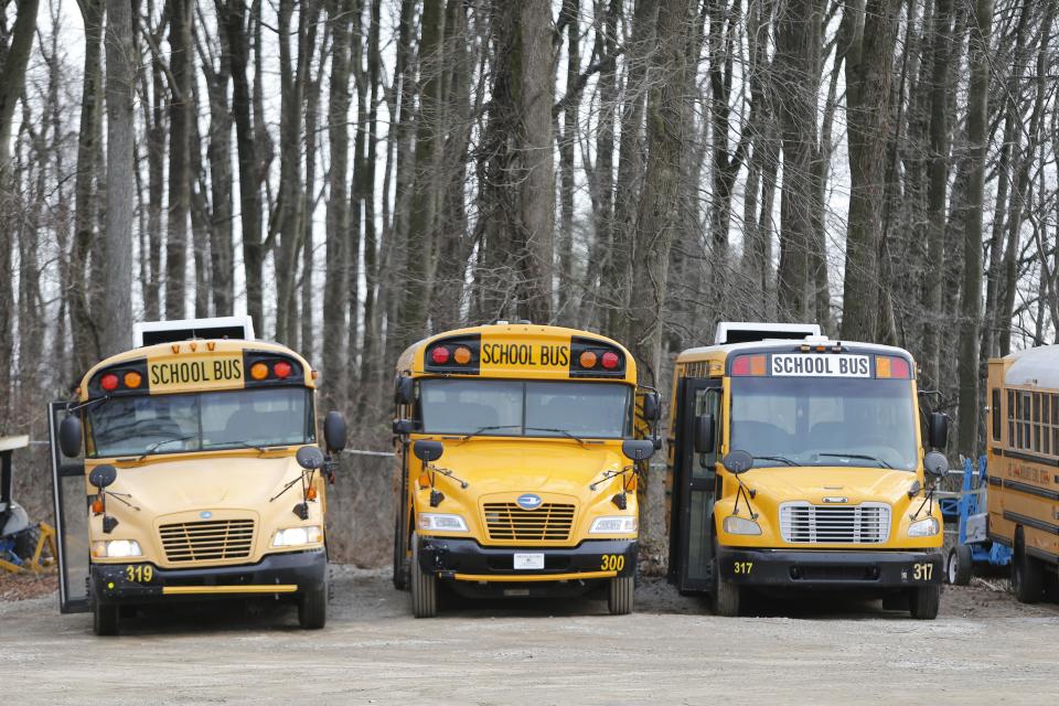 Red Clay School District buses sit in a bus yard in New Castle.