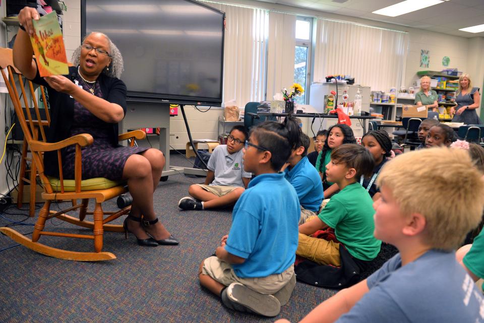 Harriet Moore, Director of Innovation and Equality for the Sarasota County School District, reads the book "Where are you from?" to students in Nohemi Hall and Bailey Hamel's third-grade classrooms at Tuttle Elementary School on Tuesday.