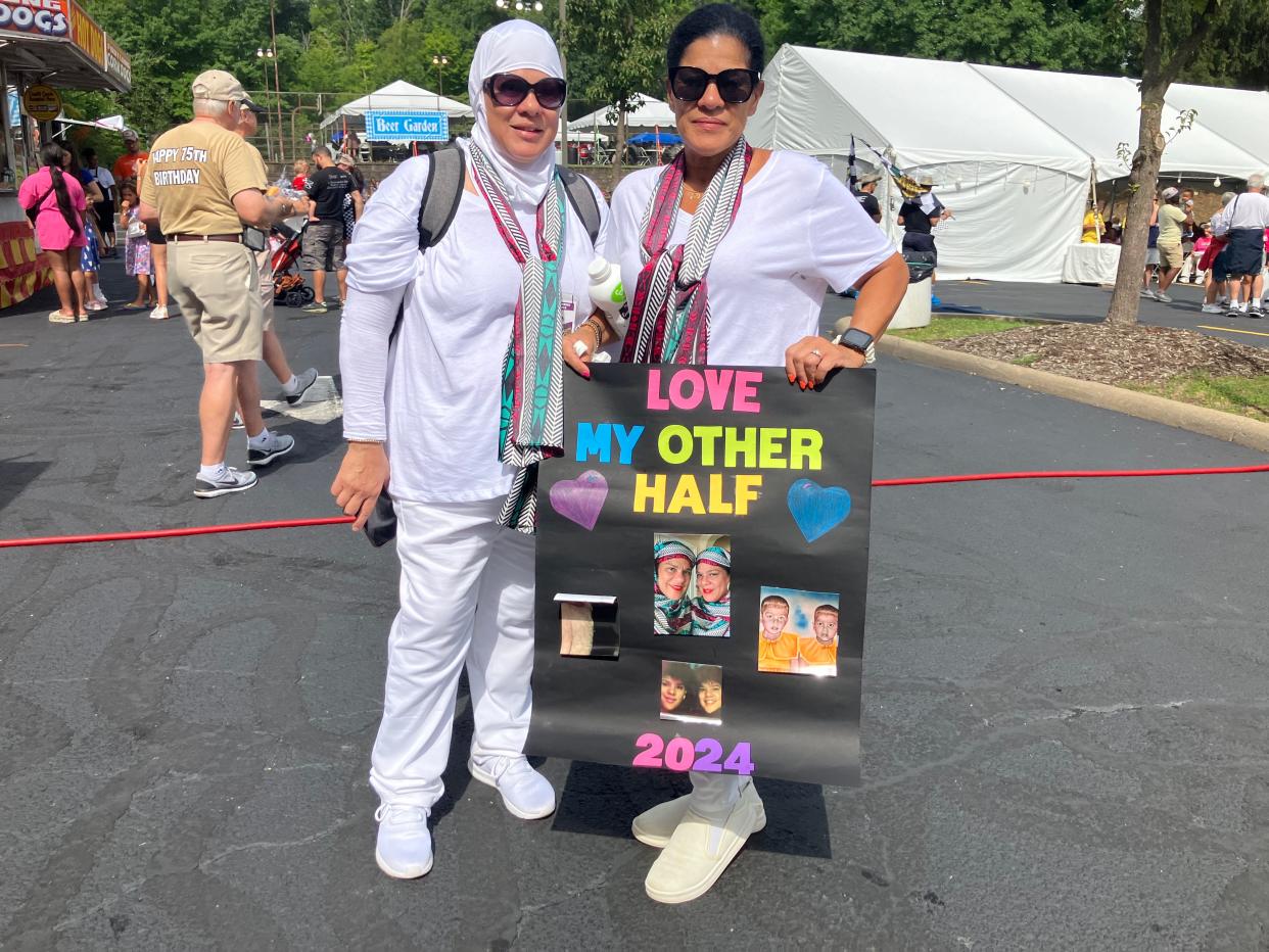 Twins A'ishah Bhatti and Sandra Shindon celebrate their bond Saturday at Twinsburg's Twins Days Festival.