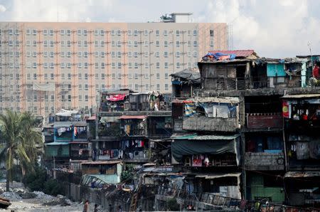 Vitas Tenement, a government housing building, stands with a new residential condominium building seen in the background, in Tondo, Manila, Philippines, May 8, 2018. REUTERS/Erik De Castro