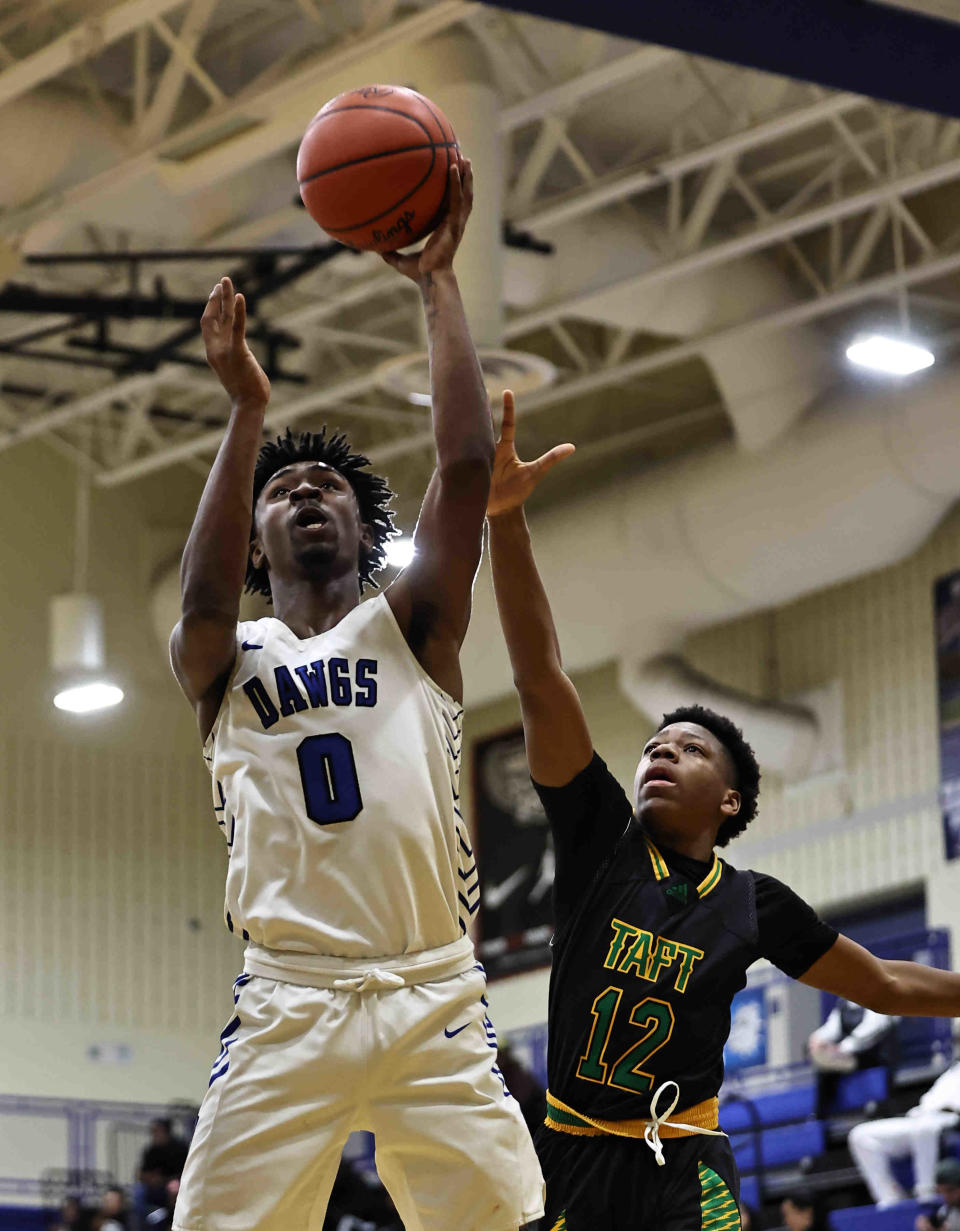 Woodward's Trell Stevenson (0) drives to the basket against Taft's James Burnett (12) during their game at Woodward High School Friday, Feb. 3, 2023.