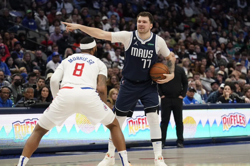 Dallas Mavericks guard Luka Doncic (77) points directions to teammates as Los Angeles Clippers forward Marcus Morris Sr. (8) guards against him during the second half of an NBA basketball game in Dallas, Sunday, Jan. 22, 2023. (AP Photo/LM Otero)