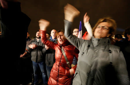 Citizens and Police officers gather during an unauthorised protest against anti-police violence in front of the Police Prefecture in Paris, France, October 21, 2016. REUTERS/Jacky Naegelen