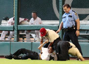Stadium security and Houston Police tackle a fan who ran on the field in the eighth inning during a baseball game between the Washington Nationals and the Houston Astros from Minute Maid Park on May 31, 2010 in Houston, Texas. (Photo by Bob Levey/Getty Images)