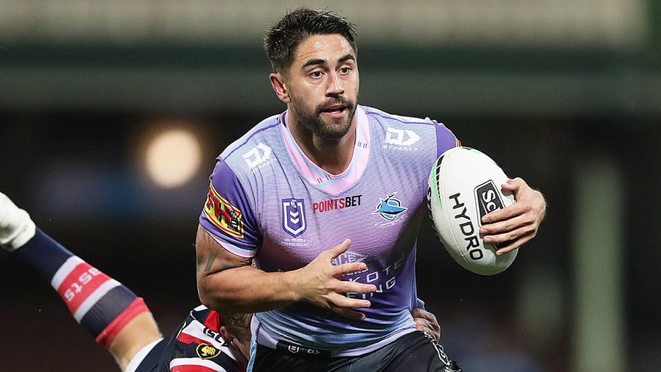 Seen here, Shaun Johnson carries the ball during an NRL match for the Sharks.