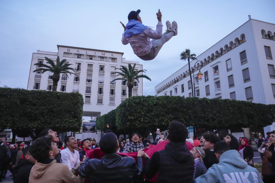 Moroccans celebrate in Rabat, Morocco, Saturday Dec. 10, 2022 their team's victory over Portugal in the World Cup quarter final soccer match played in Qatar. (AP Photo/Mosa'ab Elshamy)