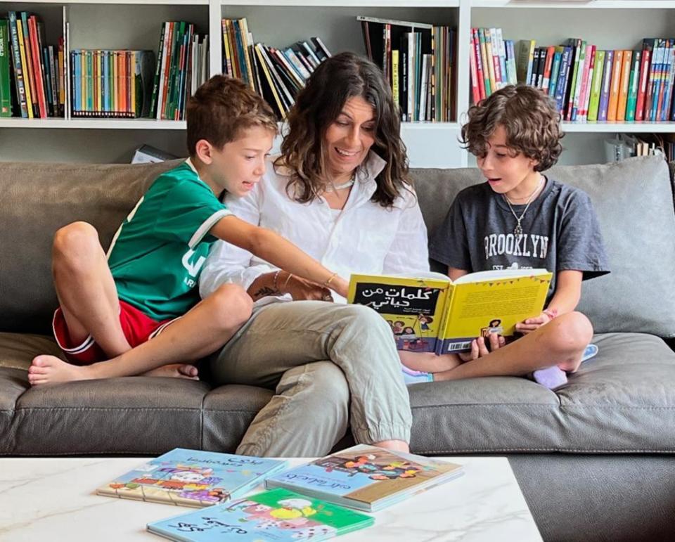 Riham Shendy reads with her children at their home in New York.  / Credit: Courtesy of Riham Shendy